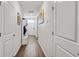 Hallway with laminate flooring, white doors and walls, coat rack with storage bench at 1074 Sennema Circle, Myrtle Beach, SC 29588