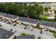 Aerial view of a condo complex surrounded by lush trees, showcasing the layout and ample parking at 1101 2Nd Ave. N # 1501, Surfside Beach, SC 29575