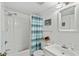Bright bathroom with a tub shower combination, coastal-themed decor, and a wicker-framed mirror at 1101 2Nd Ave. N # 1501, Surfside Beach, SC 29575