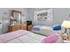 Cozy bedroom featuring two twin beds, dresser with nautical decor, and a window with sheer curtains at 1101 2Nd Ave. N # 1501, Surfside Beach, SC 29575