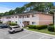 Building exterior with exterior stairs, well-manicured landscaping, and convenient parking, showing the community's appeal at 1101 2Nd Ave. N # 1501, Surfside Beach, SC 29575