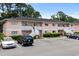 Exterior of the building with well-maintained landscaping, parking spaces, and inviting stairways to each unit at 1101 2Nd Ave. N # 1501, Surfside Beach, SC 29575