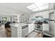 Well-equipped kitchen with stainless appliances, breakfast bar, and an open view to the living area at 1101 2Nd Ave. N # 1501, Surfside Beach, SC 29575