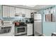 Kitchen features stainless steel appliances, white cabinets, and light blue walls, creating a bright, inviting space at 1101 2Nd Ave. N # 1501, Surfside Beach, SC 29575