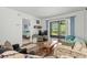 Comfortable living room flows into screened porch and includes view of connected bedroom with nautical theme at 1101 2Nd Ave. N # 1501, Surfside Beach, SC 29575
