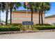Welcoming sign for Tradewinds community surrounded by lush landscaping and palm trees on a clear day at 1101 2Nd Ave. N # 1501, Surfside Beach, SC 29575