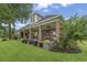 Expansive covered back porch with brick columns, ceiling fans, and outdoor dining and seating areas at 1106 Bluffton Ct., Myrtle Beach, SC 29579