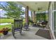 Inviting covered back porch featuring rocking chairs and outdoor seating overlooking the water at 1106 Bluffton Ct., Myrtle Beach, SC 29579