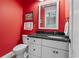 Stylish half-bath features a modern vanity with dark countertop and vibrant red walls at 1106 Bluffton Ct., Myrtle Beach, SC 29579