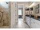 Bathroom featuring double vanity, granite countertop, decorative mirror, and a tiled walk-in shower at 1106 Bluffton Ct., Myrtle Beach, SC 29579