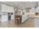 Modern kitchen with a large island, stainless steel appliances, white cabinetry and hardwood floors at 1106 Bluffton Ct., Myrtle Beach, SC 29579