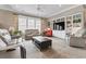 Spacious living room with built-in shelving, a comfortable seating arrangement, and natural light at 1106 Bluffton Ct., Myrtle Beach, SC 29579