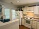 Well-lit kitchen with white cabinets, standard appliances, and a view to the backyard at 112 Palisade Loop # 112, Pawleys Island, SC 29585