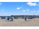 Scenic beach view with pier, blue umbrellas, and clear skies in North Myrtle Beach, South Carolina at 1201 Crooked Hook Rd., North Myrtle Beach, SC 29582