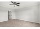 Spacious bedroom with natural light, neutral carpeting, and a ceiling fan at 1201 Crooked Hook Rd., North Myrtle Beach, SC 29582