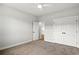 Bright bedroom with neutral carpet, ceiling fan, closet, and an entry door at 1201 Crooked Hook Rd., North Myrtle Beach, SC 29582