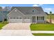 Beautiful home with a three-car garage and a well-manicured lawn and brick driveway at 1201 Crooked Hook Rd., North Myrtle Beach, SC 29582