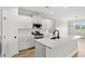 Bright kitchen featuring white cabinets, a stainless steel microwave, and quartz countertops at 1201 Crooked Hook Rd., North Myrtle Beach, SC 29582