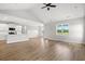 Open-concept living space with modern light fixtures, wood-look flooring, and a cathedral ceiling at 1201 Crooked Hook Rd., North Myrtle Beach, SC 29582