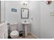 Cozy powder room with a pedestal sink, toilet, and charming coastal decorations at 121B 7Th Ave. S, Surfside Beach, SC 29575