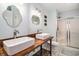 Stylish bathroom featuring a double sink vanity and a glass-enclosed shower at 121B 7Th Ave. S, Surfside Beach, SC 29575