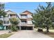 Beautiful coastal home featuring a two-story exterior with covered parking and private balconies at 121B 7Th Ave. S, Surfside Beach, SC 29575