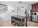 Modern kitchen area with stainless steel appliances, dark wood cabinets, and cozy breakfast nook at 121B 7Th Ave. S, Surfside Beach, SC 29575