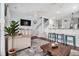 Airy living area featuring modern furnishings, a staircase, and a bar with seating at 121B 7Th Ave. S, Surfside Beach, SC 29575