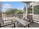 Inviting porch with wicker chairs and a table offers a cozy outdoor space for relaxation at 121B 7Th Ave. S, Surfside Beach, SC 29575