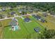 Wide aerial view of the property, showing its location within a lush, green neighborhood with a nearby pond at 1253 Kenworth Circle, Conway, SC 29526