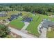 Expansive aerial shot of the property showcasing a large, well-maintained lawn, fence, and surrounding greenery at 1253 Kenworth Circle, Conway, SC 29526