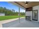 A covered patio features an outdoor ceiling fan and views of the expansive, verdant lawn at 1253 Kenworth Circle, Conway, SC 29526