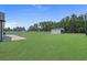 Expansive backyard with a large, well-maintained lawn and a storage shed behind a black metal fence at 1253 Kenworth Circle, Conway, SC 29526