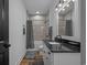 Bathroom featuring modern vanity with black countertop, tub-shower combo, and contemporary lighting fixtures at 1253 Kenworth Circle, Conway, SC 29526