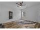 Minimalist bedroom with wood-look floors, a modern ceiling fan, and ample natural light at 1253 Kenworth Circle, Conway, SC 29526