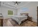 Well-lit bedroom with a modern wooden bed, tray ceiling, and large windows with backyard views at 1253 Kenworth Circle, Conway, SC 29526