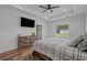 Bright bedroom with a modern ceiling fan, a door leading outside, and beautiful wood-look flooring at 1253 Kenworth Circle, Conway, SC 29526