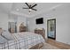 A lovely bedroom featuring wood-look floors, a modern ceiling fan, recessed lighting, and an exterior door at 1253 Kenworth Circle, Conway, SC 29526