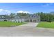 Inviting two-story home featuring a well-kept lawn, black accents, and a welcoming front entrance at 1253 Kenworth Circle, Conway, SC 29526