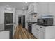 Modern kitchen featuring white cabinets, dark countertops, and sleek stainless steel appliances at 1253 Kenworth Circle, Conway, SC 29526