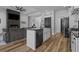 Open kitchen layout showing a white farmhouse sink, modern appliances, and an adjacent living area at 1253 Kenworth Circle, Conway, SC 29526