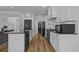 Well-lit kitchen with white cabinets, granite countertops, and stainless steel appliances at 1253 Kenworth Circle, Conway, SC 29526