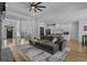 Stylish living room with open layout, wood floors, inviting couch, and connecting spaces for dining and entry at 1253 Kenworth Circle, Conway, SC 29526