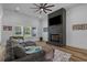 Comfortable living room featuring a brick fireplace with mounted TV and a cozy gray sectional sofa at 1253 Kenworth Circle, Conway, SC 29526