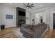 Spacious living room with wood floors and a cozy gray sectional sofa next to open doorway at 1253 Kenworth Circle, Conway, SC 29526