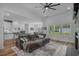 Spacious living room with wood flooring, a comfortable couch, and an open view to the stylish kitchen at 1253 Kenworth Circle, Conway, SC 29526