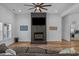 Inviting living room showcasing a brick fireplace with mounted TV and natural light from large window at 1253 Kenworth Circle, Conway, SC 29526