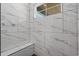 A bathroom shower featuring marble-look tile with a window providing natural light and a built-in bench at 1253 Kenworth Circle, Conway, SC 29526