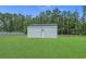 Outdoor storage shed with metal siding and roofing set on a large grassy lawn at 1253 Kenworth Circle, Conway, SC 29526