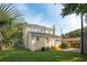Spacious backyard with lush green lawn and the home's exterior featuring a brick and siding combination at 126 Cleland St., Georgetown, SC 29440